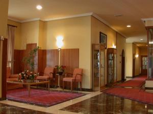 a lobby with chairs and a table in a building at Hotel Bahía Bayona in Baiona