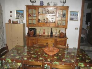 a dining room with a table and a china cabinet at Near the Duomo in Erice