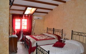 a bedroom with two beds and a window at Casa del Girasole in Genazzano