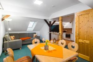 a living room with a couch and a table at Appartements und Ferienhaus Gasthof Kanzlersgrund in Oberhof