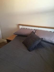 a bed with two pillows on it in a room at Modern Luxury Central Apartment in Birmingham