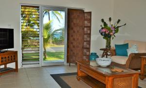 a living room with a couch and a coffee table at Banfields Retreat in Mission Beach