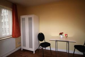 a room with a table and chairs and a window at Sleep in Hamburg St. Pauli in Hamburg