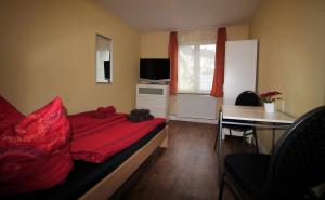 a small room with a bed with a red blanket at Sleep in Hamburg St. Pauli in Hamburg