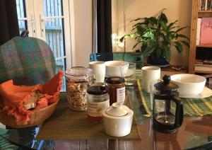 a glass table with jars of food on it at D&E Homestay in Wallingford