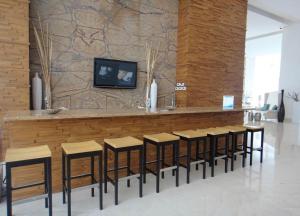 a bar with a row of stools in a room at Peninsula Mazatlan in Mazatlán