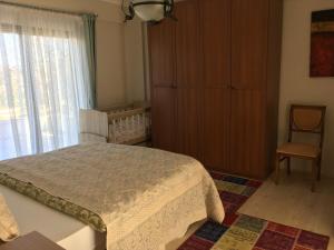 a bedroom with a bed and a crib and a window at Villa Onuk in Sapanca +29 photos