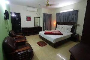 a bedroom with a bed and a chair in it at Grand Beach Resort in Cox's Bazar