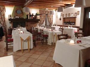a restaurant with tables and chairs with white table cloth at Hotel Locanda Da Carla in Vigevano