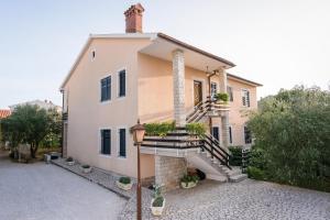 a house with a staircase in front of it at Spacious apartment in Pula for 6 persons and with a big swimming pool in Pula