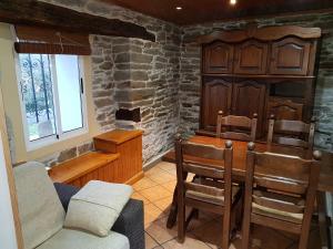 a living room with chairs and a wooden cabinet at Aqua Rooms Sarria in Sarria