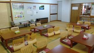 a classroom with tables and chairs in a classroom at Nozawa Dream in Nozawa Onsen