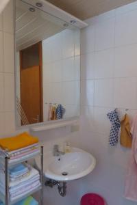 a bathroom with a sink and a mirror at Fewo Scherb in Trulben +18 photos