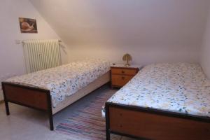 a bedroom with two twin beds and a night stand at Fewo Scherb in Trulben