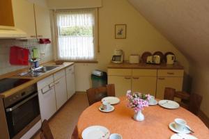 a kitchen with a table with flowers on it at Fewo Scherb in Trulben