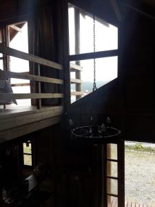 a room with a window and a table in a building at Cabana Rústica Praia do Sonho in Palhoça +34 photos