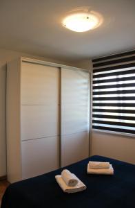 a bedroom with a bed with two towels on it at Apartmani Marin in Vrbnik