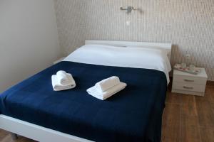 two towels are sitting on a bed in a room at Apartmani Marin in Vrbnik