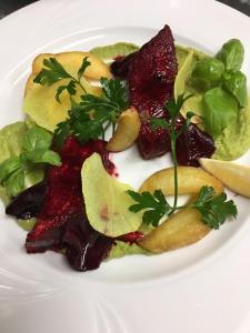 a white plate of food with fruit and vegetables at Hotel Willa Starosty in Międzyrzecz