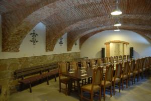 a long dining room with a long table and chairs at Penzion Bejčkův mlýn in Slavonice