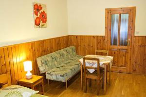 a living room with a couch and a table at Penzión Pod bránou in Poprad