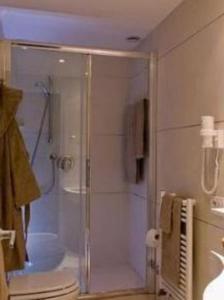 
a bathroom with a shower stall and a toilet at Hotel Daniel & Ristorante Cocchi in Parma
