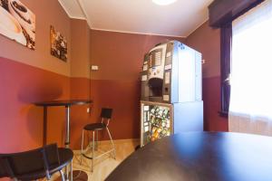 a dining room with a table and a refrigerator at Hotel Albi in Stezzano