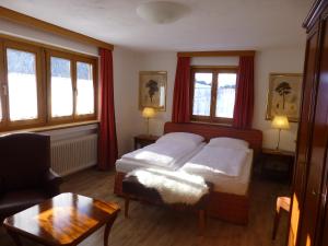 a bedroom with two beds and a coffee table at Haus Zegg in Nauders