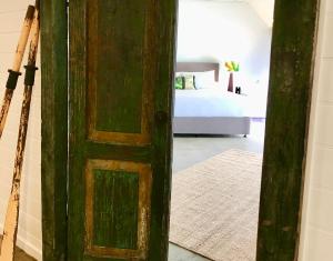 a door leading to a room with a bed and a door at Bay Breeze Boutique Accommodation in Batemans Bay