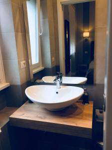 a bathroom with a white sink and a mirror at FAIROME Apartment Cassia in Rome