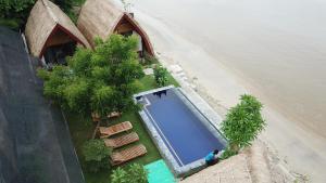 an overhead view of a swimming pool next to a beach at Krisna Bungalows and Restaurant in Sekotong