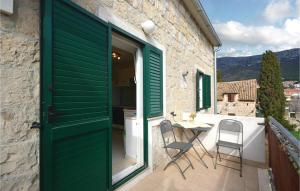 a green door on a balcony with a table and chairs at Ani Apartments in Kaštela