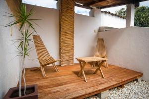 two chairs and a table on a wooden deck at Casa María Guest House in Santa Cruz Etla +51 photos