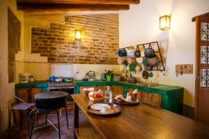 a kitchen with a wooden table with plates on it at Casa María Guest House in Santa Cruz Etla