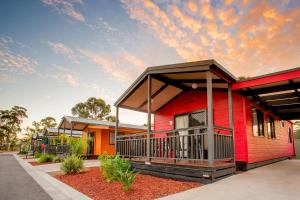 a row of houses with red and orange at BIG4 Bendigo Park Lane Holiday Park in Bendigo