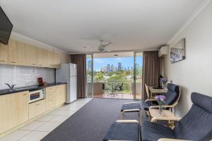 a kitchen and living room with a view of the city at The Wellington Apartment Hotel in Brisbane +37 photos