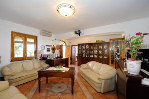 a living room with two couches and a coffee table at H.H.Le Palme in Amalfi