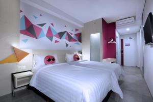 Voodi või voodid majutusasutuse favehotel Madiun toas