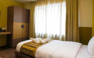 Letto o letti in una camera di Bodhi Boutique Hotel