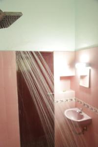 ein Badezimmer mit einem Waschbecken, einem WC und einem Spiegel in der Unterkunft Countryside inn in Tiruvankod
