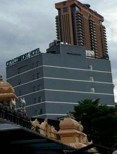 a tall building with a clock on top at City Comfort Hotel Kuala Lumpur City Center (Bukit Bintang) in Kuala Lumpur