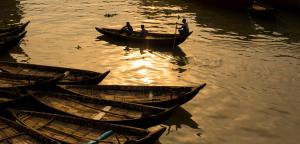three boats in the water with people in them at Japanese lodge hydrangea in Dhaka