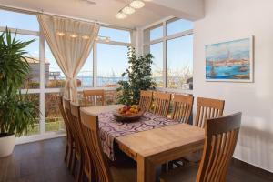 a dining room with a table with a bowl of fruit on it at Villa Mermaid Your Croatian Haven with Luxury Pool and Scenic Views in Podstrana