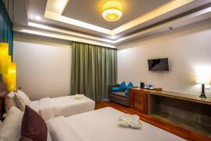 Voodi või voodid majutusasutuse The Tito Suite Residence toas
