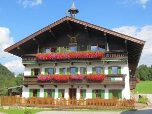 a house with flower boxes on the front at Bauernhof Großwolfing- Appartementhaus Fischbacher in Ebbs