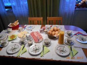 a table with plates and bowls of food on it at Haus Loidl in Sankt Gallen