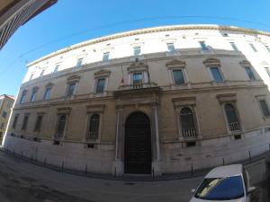 a building with a reflection of a car in a mirror at Casa Ohana in Ancona +7 photos