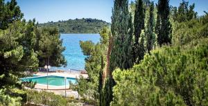 a swimming pool with a view of a lake at Victoria Mobilehome Camping Imperial in Vodice