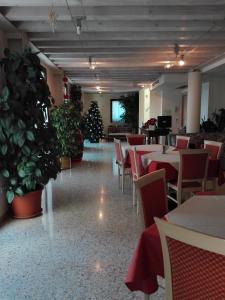a restaurant with tables and chairs and a christmas tree at Al Bagolaro in Crocetta del Montello