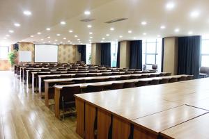a large room with rows of tables and chairs at Thank Inn Chain Hotel Hebei Shijiazhuang Xingtang Town North Yongchang Road in Jicun